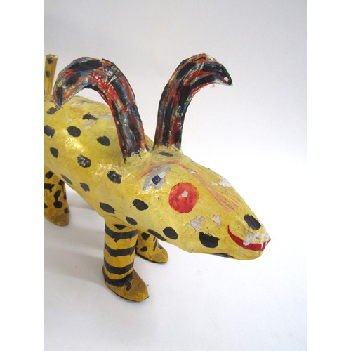 7552 - JULIE ARKELL (XX/XXI) A a folk art papier mache yellow dog figure. 26cm high x 36cm long