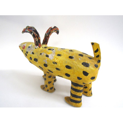 7552 - JULIE ARKELL (XX/XXI) A a folk art papier mache yellow dog figure. 26cm high x 36cm long