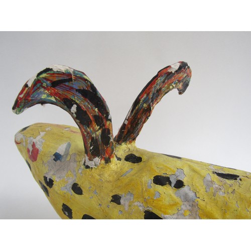 7552 - JULIE ARKELL (XX/XXI) A a folk art papier mache yellow dog figure. 26cm high x 36cm long