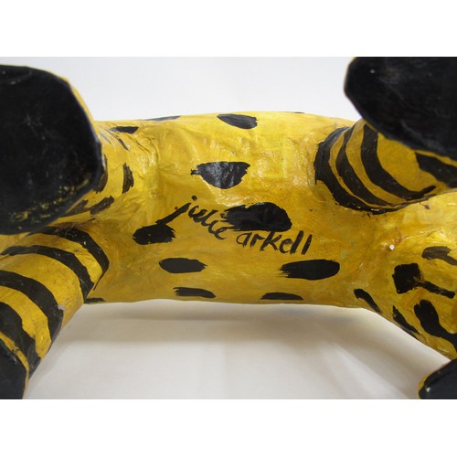 7552 - JULIE ARKELL (XX/XXI) A a folk art papier mache yellow dog figure. 26cm high x 36cm long