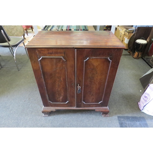 1498 - A 19th Century mahogany cabinet, the two doors opening to reveal six drawers, raised on ogee bracket... 