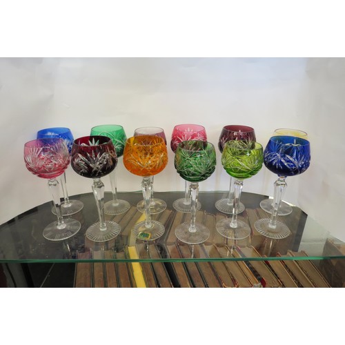 1438 - A group of twelve crystal coloured hock glasses one with Kirkstall Lausitzer Elias label to base