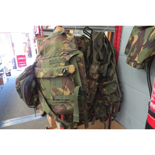 1229 - Five Army jackets, two Webbing jackets, trousers, camouflage and backpack