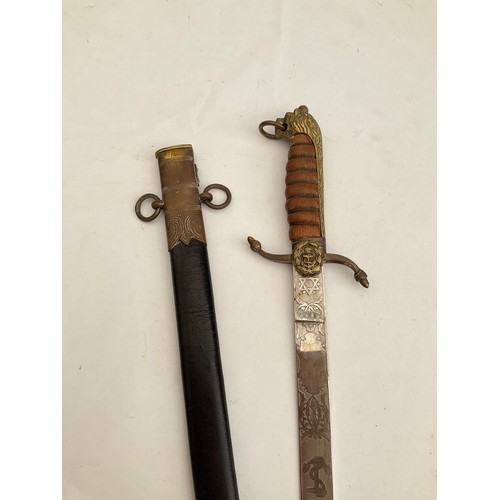 8087 - A replica of a Naval officer’s dirk, the blade maker Manton & Co. England, brass lion hilt, leather ... 