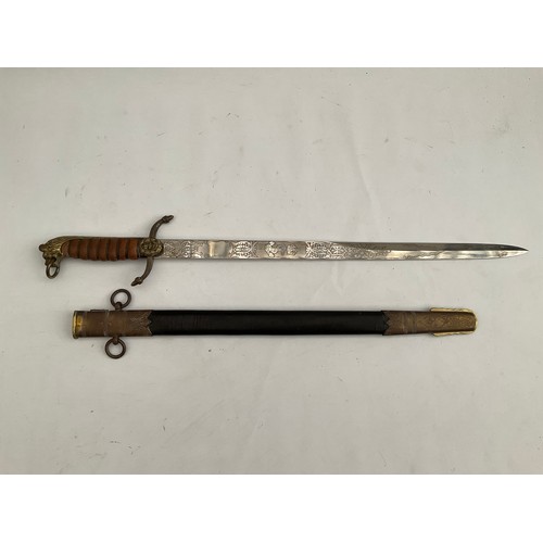 8087 - A replica of a Naval officer’s dirk, the blade maker Manton & Co. England, brass lion hilt, leather ... 