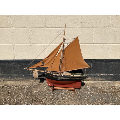 8013 - A model of a fishing smack, red and black hull with gilt band, marked ‘Essex’, plaque with provenanc... 