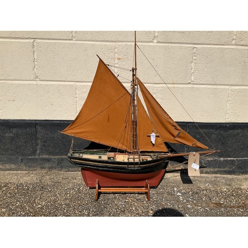 8013 - A model of a fishing smack, red and black hull with gilt band, marked ‘Essex’, plaque with provenanc... 