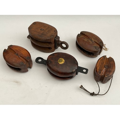 8040 - Five various vintage nautical pulleys