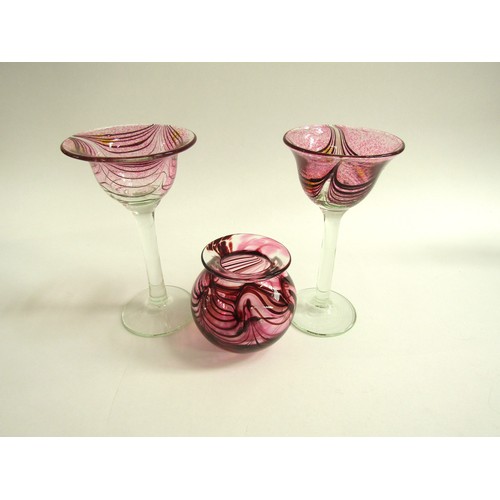 7169 - GEORGE ELLIOTT (1933-1998): Two studio blown wine glasses with pink combing technique pattern over a... 