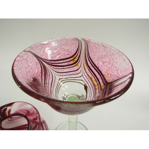 7169 - GEORGE ELLIOTT (1933-1998): Two studio blown wine glasses with pink combing technique pattern over a... 