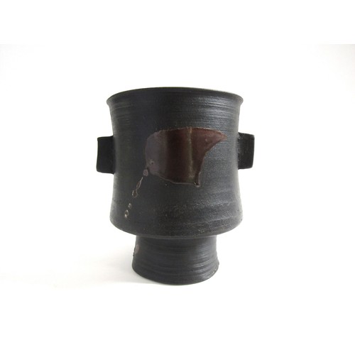 7079 - JANET LEACH (1918-1997) (ARR) A St Ives Pottery black stoneware pedestal vase with twin lug handles ... 