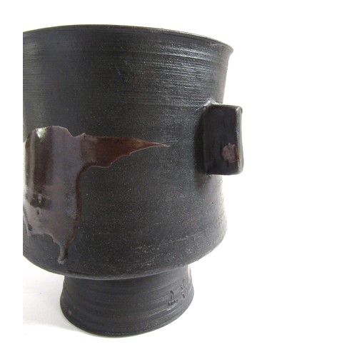 7079 - JANET LEACH (1918-1997) (ARR) A St Ives Pottery black stoneware pedestal vase with twin lug handles ... 