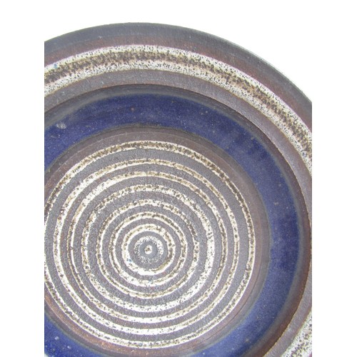 7070 - ROBIN WELCH (1936-2019) A studio pottery charger, deep blue and off-white, impressed mark underneath... 