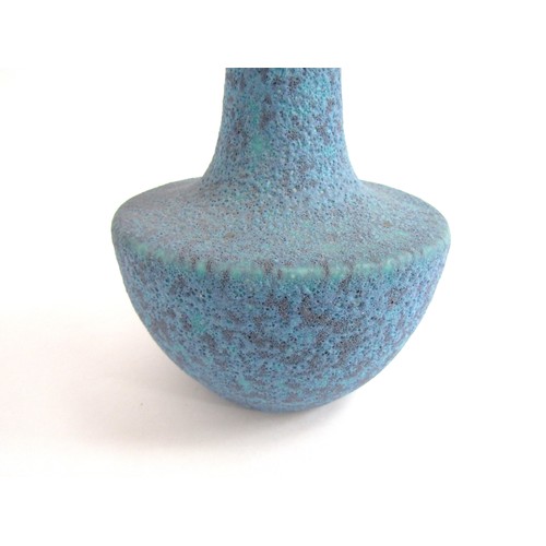 7056 - A studio ceramic flared vase with high fired volcanic blue glaze.  Unmarked 25.3cm high