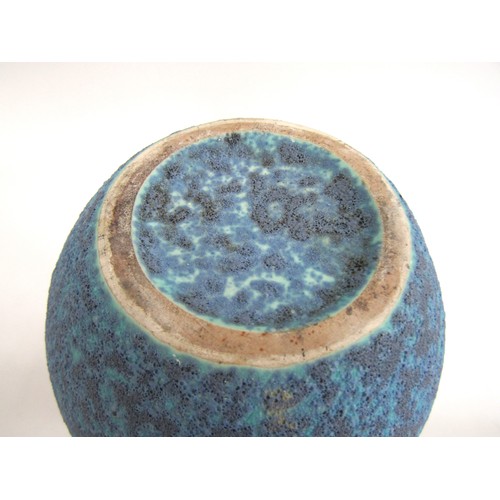 7056 - A studio ceramic flared vase with high fired volcanic blue glaze.  Unmarked 25.3cm high