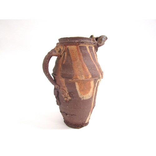 7059 - PETER SMITH (b.1941) A studio pottery earthenware jug, rough textured with poured slip detail. Impre... 