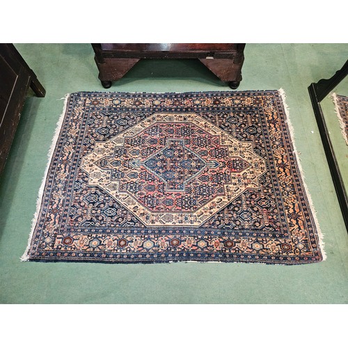 4491 - A blue ground geometric design rug with multiple borders, 127cm x 160cm