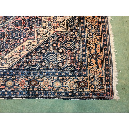 4491 - A blue ground geometric design rug with multiple borders, 127cm x 160cm