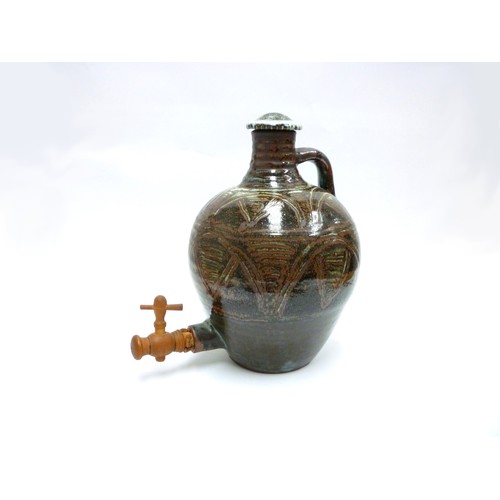 7075 - An Abuja Pottery stoneware flagon with screw top in the Michael Cardew tradition, strap handle. Iron... 