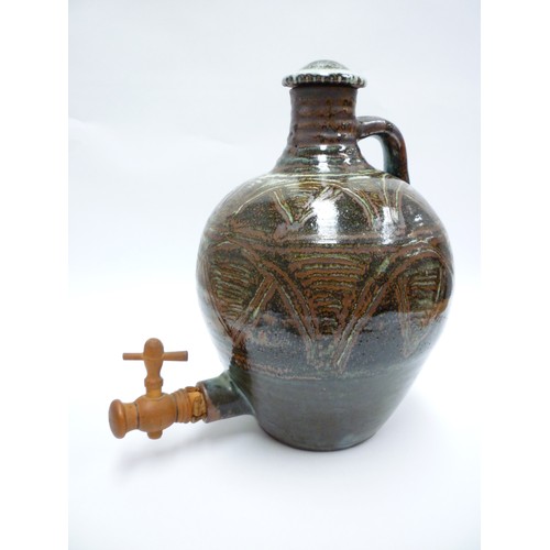 7075 - An Abuja Pottery stoneware flagon with screw top in the Michael Cardew tradition, strap handle. Iron... 