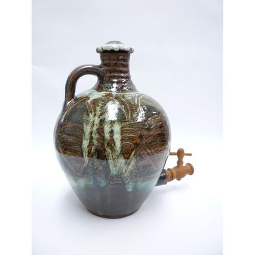 7075 - An Abuja Pottery stoneware flagon with screw top in the Michael Cardew tradition, strap handle. Iron... 