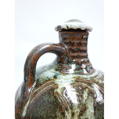 7075 - An Abuja Pottery stoneware flagon with screw top in the Michael Cardew tradition, strap handle. Iron... 