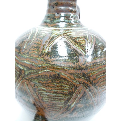 7075 - An Abuja Pottery stoneware flagon with screw top in the Michael Cardew tradition, strap handle. Iron... 