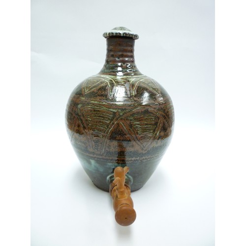 7075 - An Abuja Pottery stoneware flagon with screw top in the Michael Cardew tradition, strap handle. Iron... 