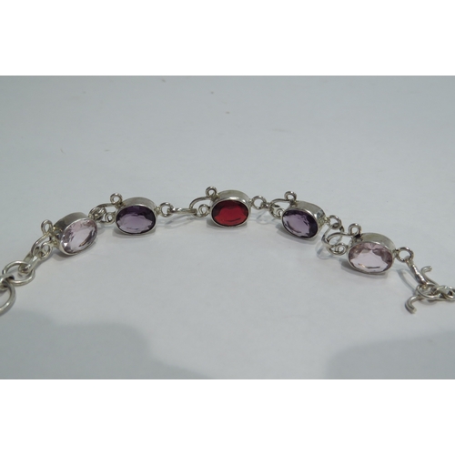 4422A - A silver bracelet with pink, purple and red gem stones