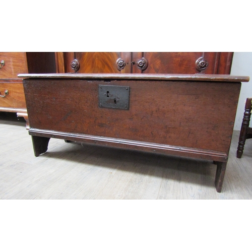 4004 - A 17th Century oak planked coffer of small proportions, the iron hinged lid over arch end supports, ... 