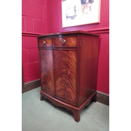 4103 - A 'Bevan and Funnell' George III style flame mahogany bow front media cabinet, the rising top over t... 