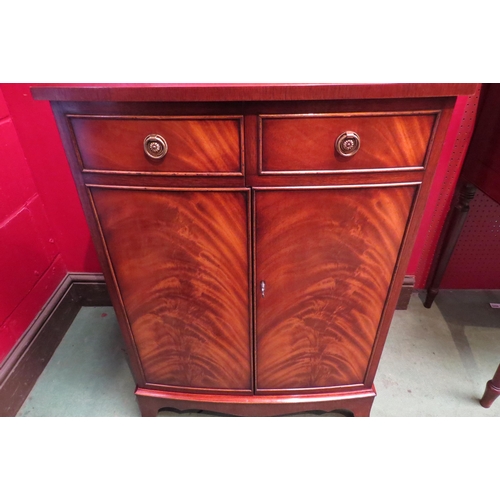 4103 - A 'Bevan and Funnell' George III style flame mahogany bow front media cabinet, the rising top over t... 