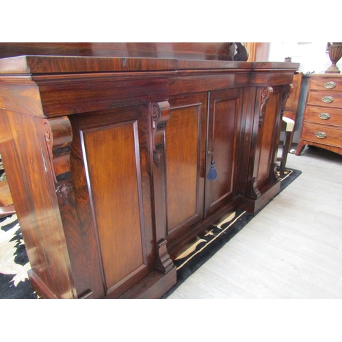 4053 - Circa 1830 a William IV rosewood breakfront chiffonier, the raised shelf back with caved 