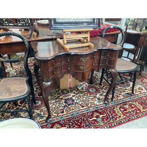 4070 - A Georgian burr walnut serpentine front lowboy/side table, the six drawers with oak linings over a s... 