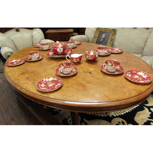 4075 - A Circa 1860 mid-Victorian burr walnut oval tilt-top table over a baluster turned column base and ca... 