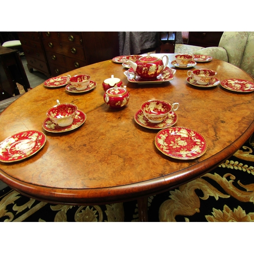 4075 - A Circa 1860 mid-Victorian burr walnut oval tilt-top table over a baluster turned column base and ca... 