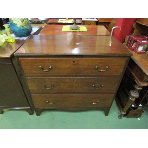 4131 - A Circa 1840 planked oak chest of three graduating long drawers with brass swan neck handles over br... 