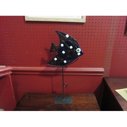 4134 - A candle stand as a blue glass fish on tall metal base, 45cm tall     (R) £0 (E) £15-20