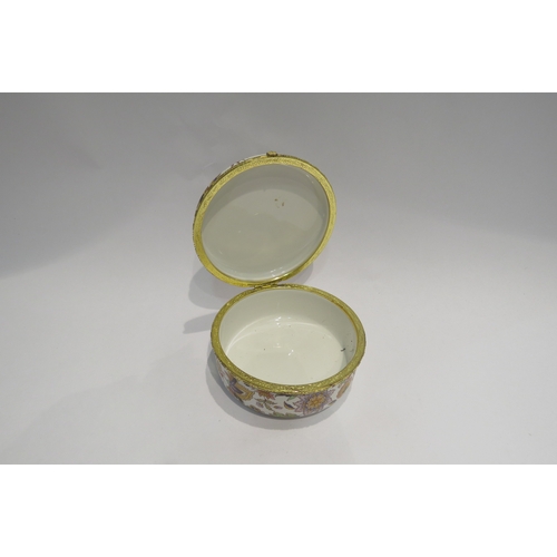 4345 - A large enamel lidded box with flower decoration, 6.5cm deep x 14cm diameter  (R)  £10