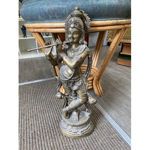 4146 - A large temple cast brass figure of Krishna, 74cm tall