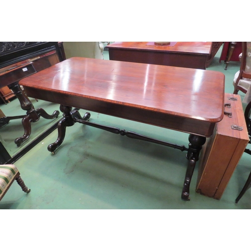 4185 - A rosewood round cornered chamfered edge top library table, the two frieze drawers with 