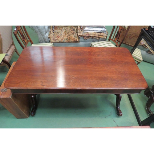 4185 - A rosewood round cornered chamfered edge top library table, the two frieze drawers with 