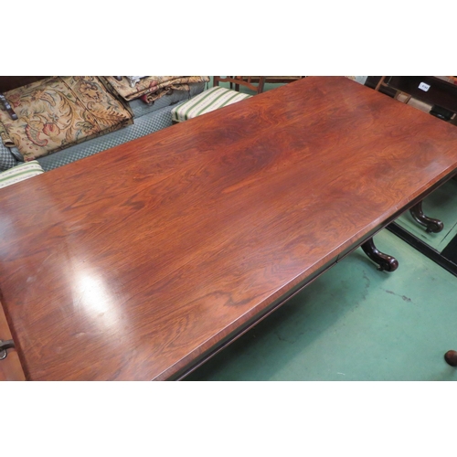 4185 - A rosewood round cornered chamfered edge top library table, the two frieze drawers with 