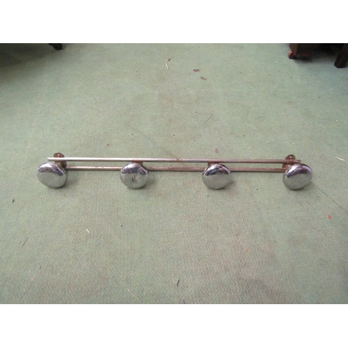 4232 - An Art Deco style chromed metal four hook coat hanger, 56cm long