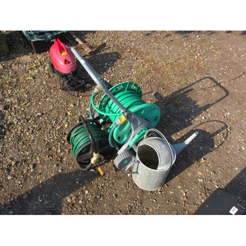 3473 - Two hoses on reels and a galvanised watering can