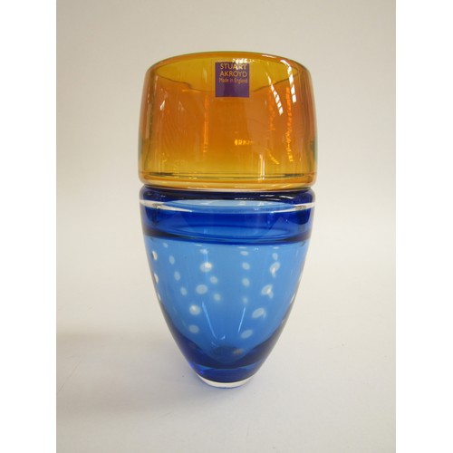 7154 - A Stuart Akroyd fish eye vase in blue and amber.  Signed to base. 19cm high