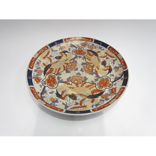 4086 - An Oriental Imari pallette wall charger with bird and floral design, 36cm diameter