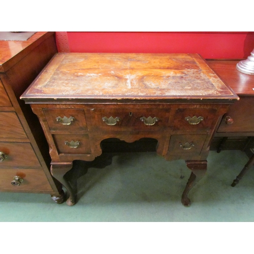 4097 - A Queen Anne style walnut veneer five drawer dressing table with brass handles on cabriole legs to p... 