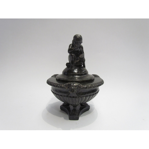 4133 - An ornate carved stone inkwell in the form of an urn on tripod feet with lion masks, cover with wing... 