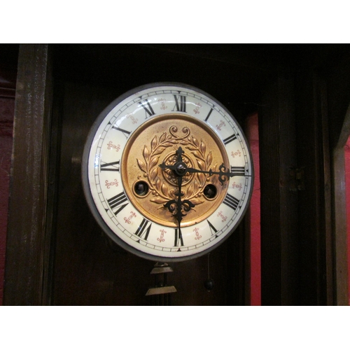 4159 - A 20th Century mahogany cased wall clock with enamel face, R & A on pendulum, with key, door hinge a... 